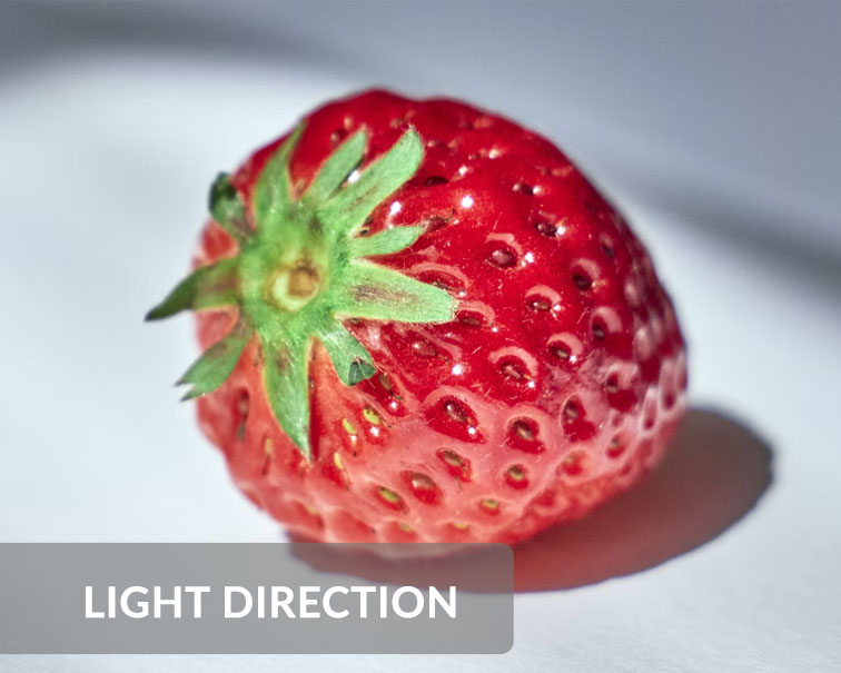 image shows a strawberry with light source at the side