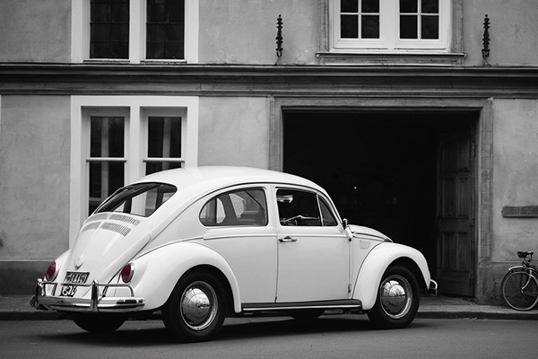 A captivating black-and-white photograph of a classic Volkswagen Beetle