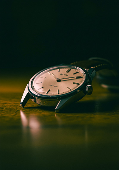 After - a vintage wristwatch resting on a wooden table
