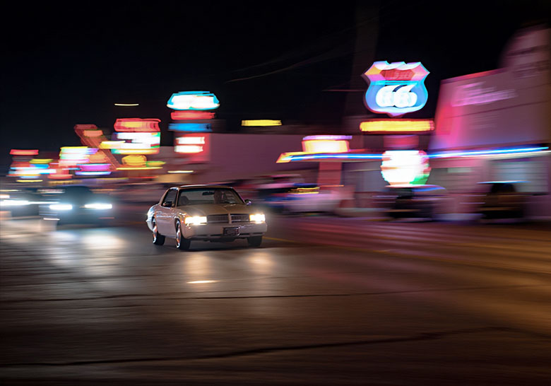 before - route 66 with a car driving by light in the background