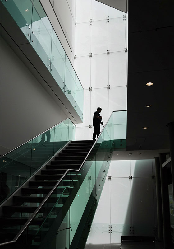 before - silhouette of a persons cleaning a glass staircase