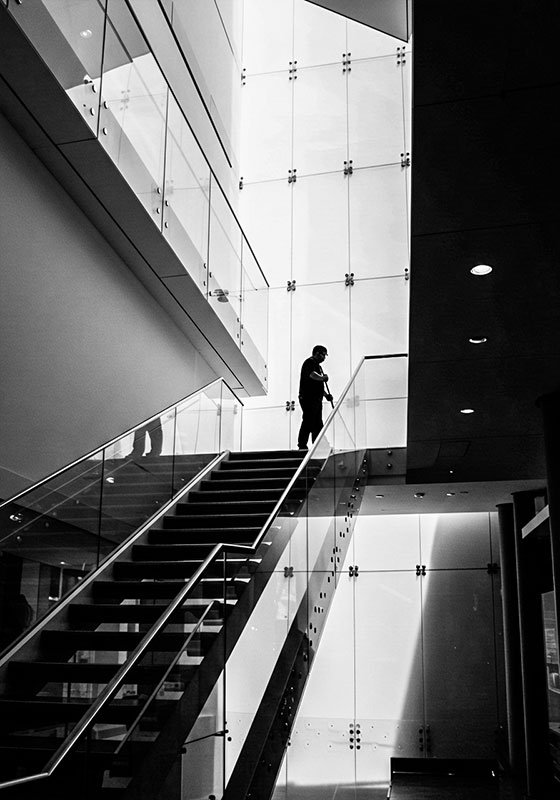 with preset - silhouette of a persons cleaning a glass staircase