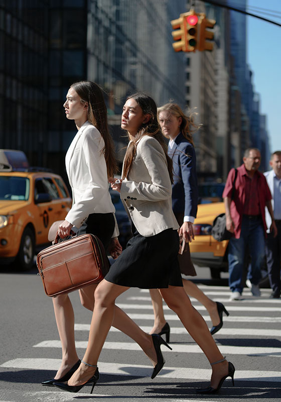 before - a group of young woman are crossing the street