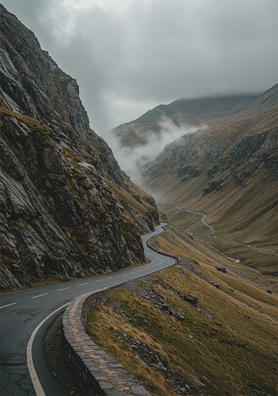 before - scenic, winding road cutting through a rugged mountainous landscape
