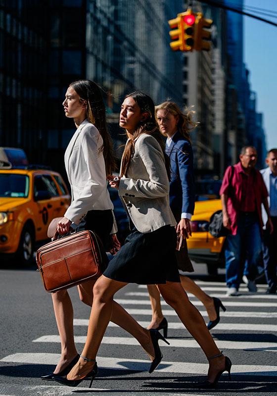 with preset - a group of young woman are crossing the street