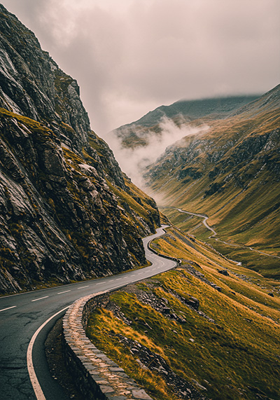 with preset - scenic, winding road cutting through a rugged mountainous landscape