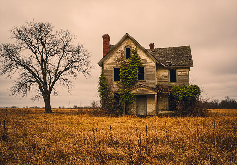 with preset - abandoned, weathered house standing alone in a desolate field