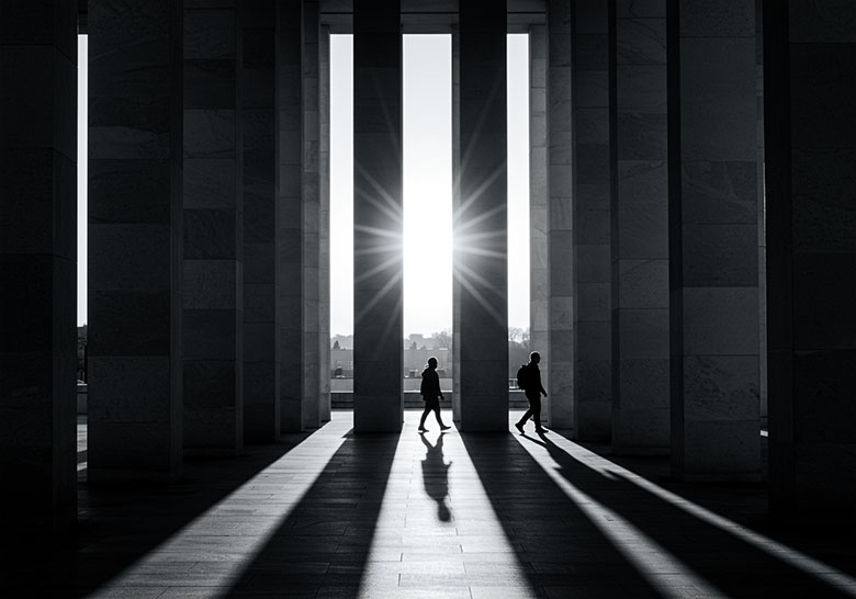 with preset - two persons walking between tall columns