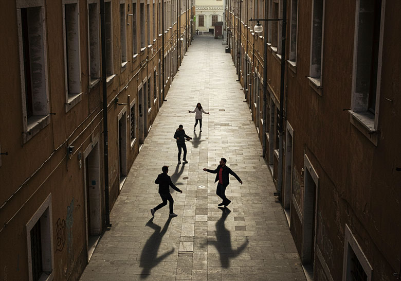 before - four people playing in a courtyard