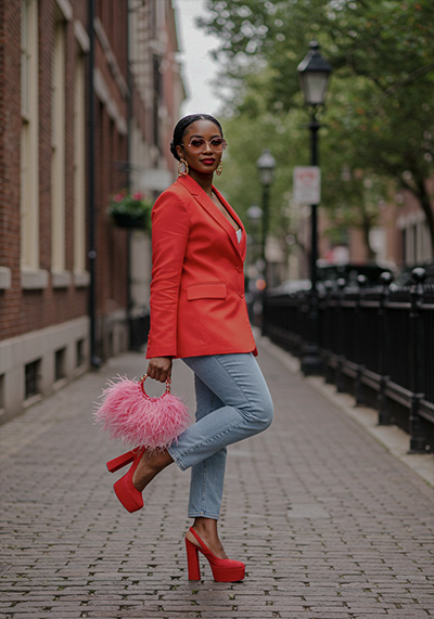 before - stylish woman standing on a city sidewalk