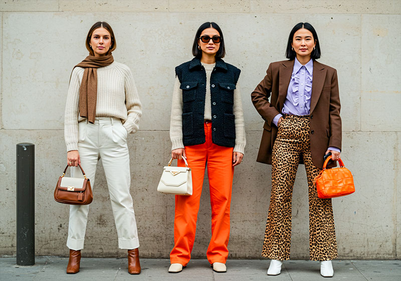 preset example - three stylish women standing side by side on a city sidewalk