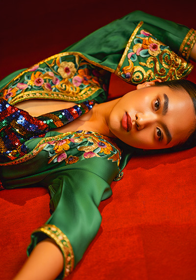 preset example - a serene model with a calm and introspective facial expression wearing a luxurious green satin dress