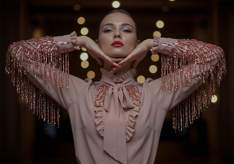 before - fashion photo of a glamorous woman posing against a dark background
