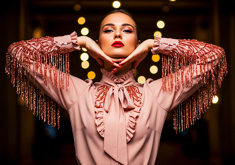 with preset - fashion photo of a glamorous woman posing against a dark background